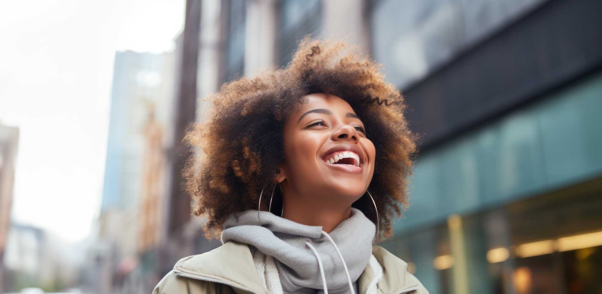 Uma mulher adulta sorrindo e olhando para o alto.